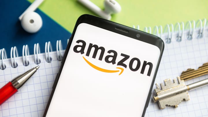 In this photo illustration, an Amazon logo seen displayed on...