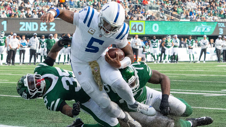 Nov 17, 2024; East Rutherford, New Jersey, USA; Indianapolis Colts quarterback Anthony Richardson (5) scores a touchdown over New York Jets safety Jalen Mills (35) and defensive end Micheal Clemons (72) in the first half at MetLife Stadium. Mandatory Credit: Robert Deutsch-Imagn Images