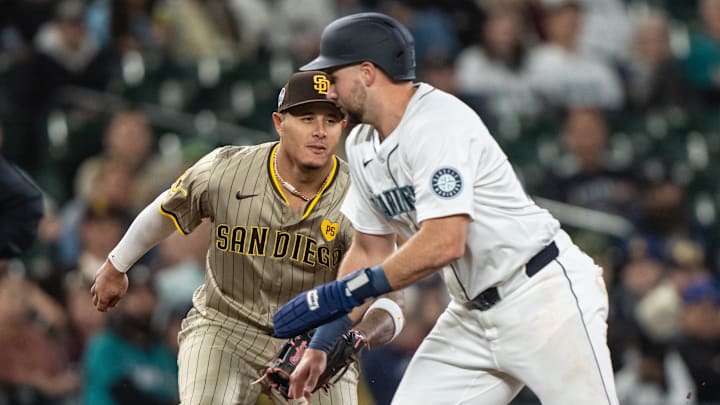 San Diego Padres third baseman Manny Machado (left) tags out Seattle Mariners catcher Cal Raleigh in a game Sept. 11 at T-Mobile Park.