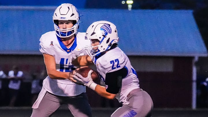 Mukwonago running back Mason Radobicky (22) takes a hand-off from quarterback Mason Kelley (13) during the game at Muskego on Friday, Sept. 13, 2024. Mukwonago running back Mason Radobicky (22) takes a hand-off from quarterback Mason Kelley (13) during the game at Muskego on Friday, Sept. 13, 2024.