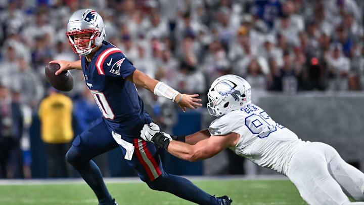 Oct 5, 2025; Orchard Park, New York, USA; New England Patriots quarterback Drake Maye (10) avoids a tackle by Buffalo Bills defensive end Joey Bosa (97) in the fourth quarter at Highmark Stadium. Oct 5, 2025; Orchard Park, New York, USA; New England Patriots quarterback Drake Maye (10) avoids a tackle by Buffalo Bills defensive end Joey Bosa (97) in the fourth quarter at Highmark Stadium.