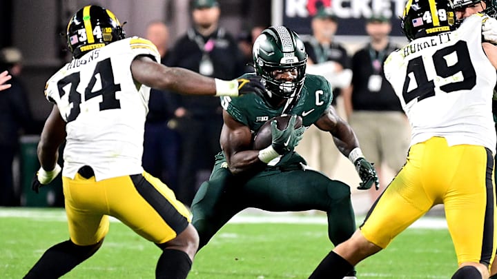 Oct 19, 2024; East Lansing, Michigan, USA; Michigan State Spartans running back Nate Carter (5) runs against Iowa Hawkeyes linebacker Jay Higgins (34) and defensive lineman Ethan Hurkett (49) in the fourth quarter at Spartan Stadium. Mandatory Credit: Dale Young-Imagn Images Oct 19, 2024; East Lansing, Michigan, USA; Michigan State Spartans running back Nate Carter (5) runs against Iowa Hawkeyes linebacker Jay Higgins (34) and defensive lineman Ethan Hurkett (49) in the fourth quarter at Spartan Stadium. Mandatory Credit: Dale Young-Imagn Images