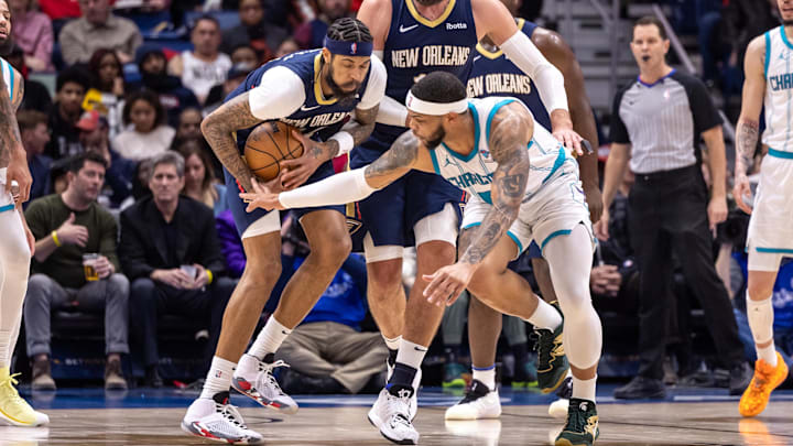 Jan 17, 2024; New Orleans, Louisiana, USA;  Charlotte Hornets forward Miles Bridges (0) attempts to steal the ball from New Orleans Pelicans forward Brandon Ingram (14) during the second half at Smoothie King Center.