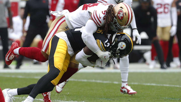 Pittsburgh Steelers wide receiver George Pickens (14) is tackled by San Francisco 49ers linebacker Fred Warner (54)