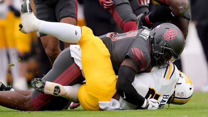 Oklahoma Sooners linebacker Kobie McKinzie (11) brings down Missouri Tigers running back Ahmad Hardy (29) during a college football game between the University of Oklahoma Sooners (OU) and the Missouri Tigers at Gaylord Family — Oklahoma Memorial Stadium in Norman on Saturday. Oklahoma Sooners linebacker Kobie McKinzie (11) brings down Missouri Tigers running back Ahmad Hardy (29) during a college football game between the University of Oklahoma Sooners (OU) and the Missouri Tigers at Gaylord Family — Oklahoma Memorial Stadium in Norman on Saturday.