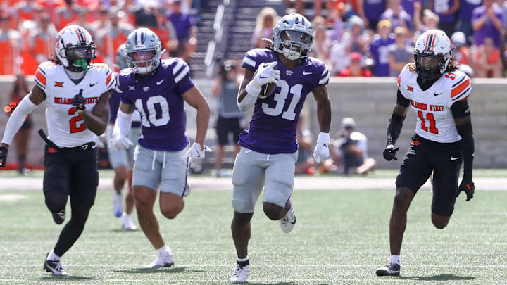 Sep 28, 2024; Manhattan, Kansas, USA; Kansas State Wildcats running back DJ Giddens (31) runs for a 66-yard touchdown against the Oklahoma State Cowboys in the third quarter at Bill Snyder Family Football Stadium. Mandatory Credit: Scott Sewell-Imagn Images
