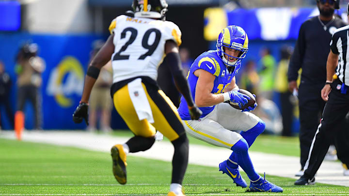 Oct 22, 2023; Inglewood, California, USA; Los Angeles Rams wide receiver Cooper Kupp (10) runs the ball against Pittsburgh Steelers cornerback Levi Wallace (29) during the first half at SoFi Stadium. Mandatory Credit: Gary A. Vasquez-Imagn Images