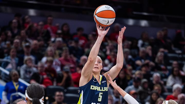Apr 30, 2026; Indianapolis, IN, USA; Dallas Wings guard Paige Bueckers (5)  shoots the ball while Indiana Fever guard Sophie Cunningham (8) defends in the first half at the Gainbridge Fieldhouse. Mandatory Credit: Trevor Ruszkowski-Imagn Images