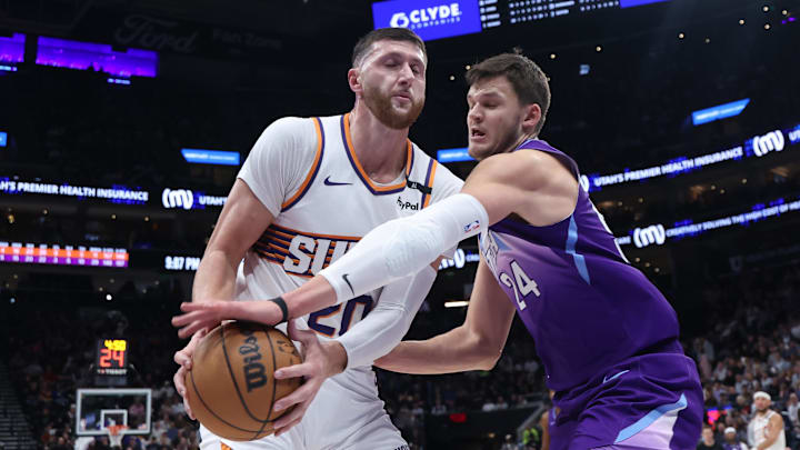 Dec 13, 2024; Salt Lake City, Utah, USA; Phoenix Suns center Jusuf Nurkic (20) and Utah Jazz center Walker Kessler (24) play for a loose ball during the third quarter at Delta Center. Mandatory Credit: Rob Gray-Imagn Images