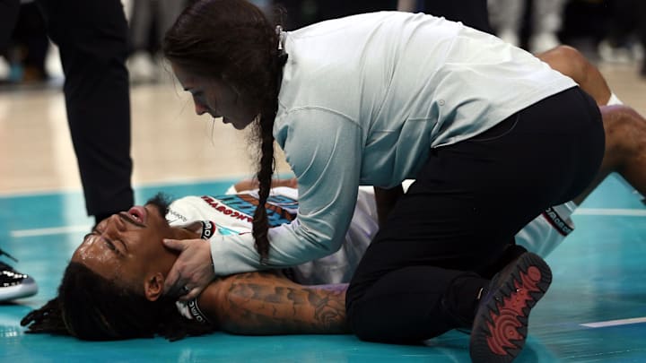 Apr 24, 2025; Memphis, Tennessee, USA; Memphis Grizzlies guard Ja Morant (12) is checked by medical staff as he lays on the court after being fouled during the second quarter against the Oklahoma City Thunder during game three for the first round of the 2024 NBA Playoffs at FedExForum. Mandatory Credit: Petre Thomas-Imagn Images Apr 24, 2025; Memphis, Tennessee, USA; Memphis Grizzlies guard Ja Morant (12) is checked by medical staff as he lays on the court after being fouled during the second quarter against the Oklahoma City Thunder during game three for the first round of the 2024 NBA Playoffs at FedExForum. Mandatory Credit: Petre Thomas-Imagn Images
