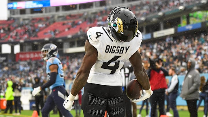 Dec 8, 2024; Nashville, Tennessee, USA; Jacksonville Jaguars running back Tank Bigsby (4) celebrates his touchdown with his teammates against the Tennessee Titans during the second half at Nissan Stadium. Mandatory Credit: Steve Roberts-Imagn Images Dec 8, 2024; Nashville, Tennessee, USA; Jacksonville Jaguars running back Tank Bigsby (4) celebrates his touchdown with his teammates against the Tennessee Titans during the second half at Nissan Stadium. Mandatory Credit: Steve Roberts-Imagn Images