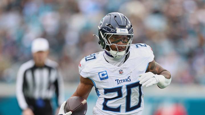 Jan 4, 2026; Jacksonville, Florida, USA; Tennessee Titans running back Tony Pollard (20) runs the ball against the Jacksonville Jaguars during the first quarter at EverBank Stadium. Mandatory Credit: Morgan Tencza-Imagn Images