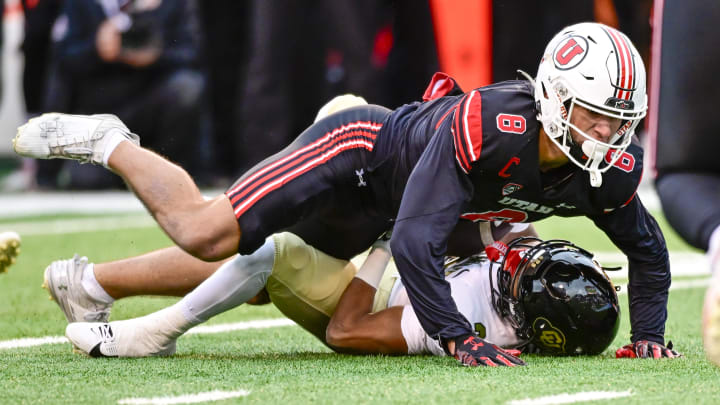 Nov 25, 2023; Salt Lake City, Utah, USA; Colorado Buffaloes running back Dylan Edwards (3) gets tackled by Utah Utes safety Cole Bishop (8) at Rice-Eccles Stadium. Mandatory Credit: Christopher Creveling-USA TODAY Sports