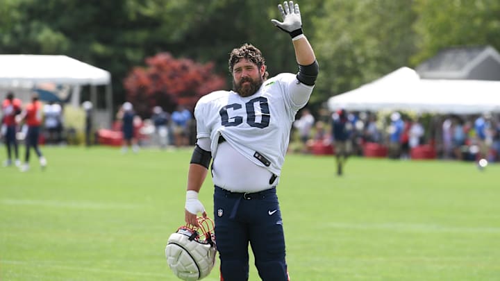 Aug 03, 2024; Foxborough, MA, USA; New England Patriots center David Andrews (60) waves to his son at training camp at Gillette Stadium. Mandatory Credit: Eric Canha-Imagn Images