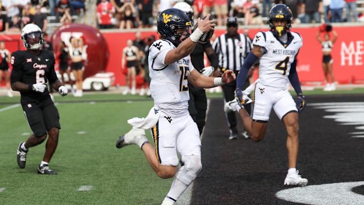 Nov 1, 2025; Houston, Texas, USA; West Virginia Mountaineers quarterback Scotty Fox Jr. (15) rushes for a touchdown against the Houston Cougars in the second half at TDECU Stadium. Mandatory Credit: Thomas Shea-Imagn Images