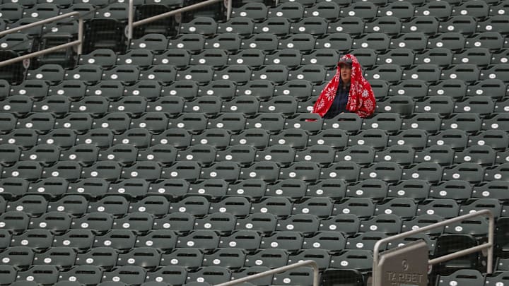 A solitary fan sits in a section and watches in a drizzle as the Chicago White Sox play the Minnesota Twins in the second inning at Target Field in Minneapolis on April 24, 2025.
