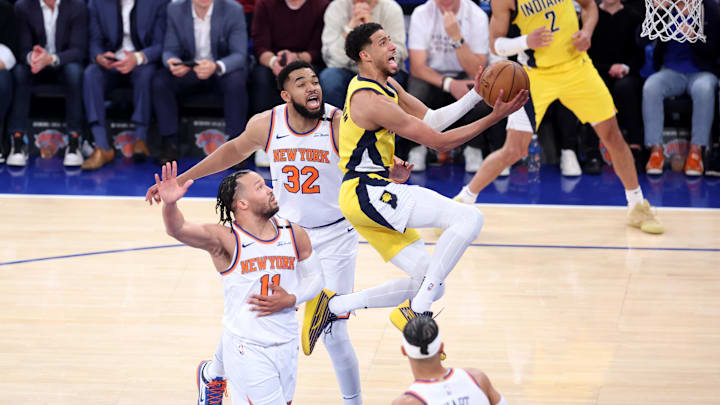 Indiana Pacers guard Tyrese Haliburton (0) shoots against New York Knicks guard Jalen Brunson (11) and center Karl-Anthony Towns (32) in the first quarter during game one of the Eastern Conference Finals.