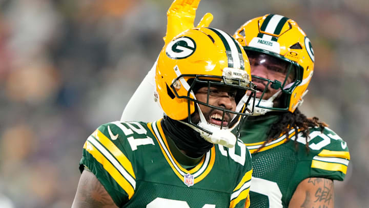 Dec 27, 2025; Green Bay, Wisconsin, USA; Green Bay Packers cornerback Nate Hobbs (21) and Green Bay Packers defensive end Arron Mosby (53) celebrate after a play during the first quarter against the Baltimore Ravens at Lambeau Field. Mandatory Credit: Kayla Wolf-Imagn Images