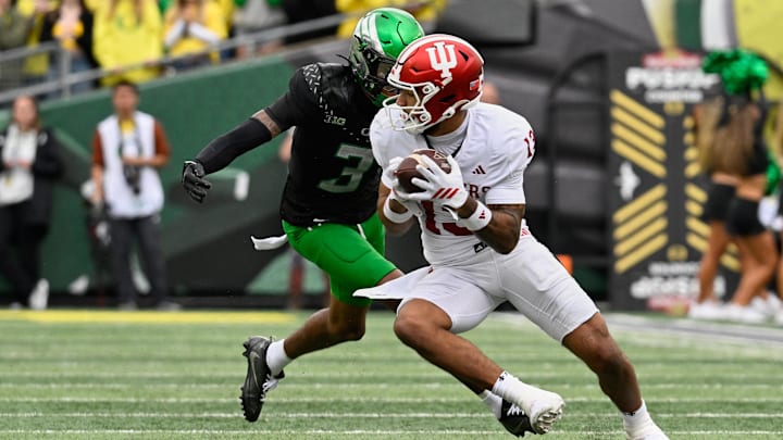 Oct 11, 2025; Eugene, Oregon, USA; Indiana Hoosiers wide receiver Elijah Sarratt (13) runs with the ball against Oregon Ducks defensive back Sione Laulea (3) during the second quarter at Autzen Stadium. 