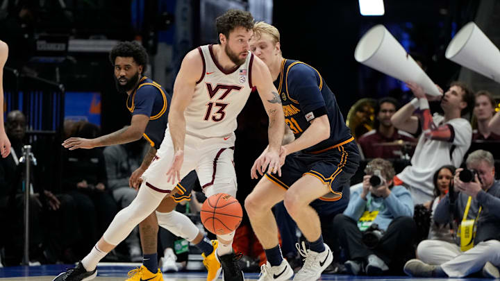 Mar 11, 2025; Charlotte, NC, USA; Virginia Tech Hokies forward Ben Burnham (13) with the ball as California Golden Bears forward Rytis Petraitis (31) defends in the second half at Spectrum Center. Mandatory Credit: Bob Donnan-Imagn Images