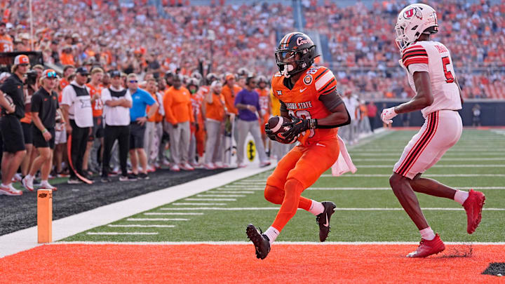 Oklahoma State's Brennan Presley (80) scores a 2-point conversion as Utah's Zemaiah Vaughn (5) defends in the second half of the college football between the Oklahoma State University Cowboys and the Utah Utes at Boone Pickens Stadium in Stillwater, Okla., Saturday, Sept., 21, 2024.