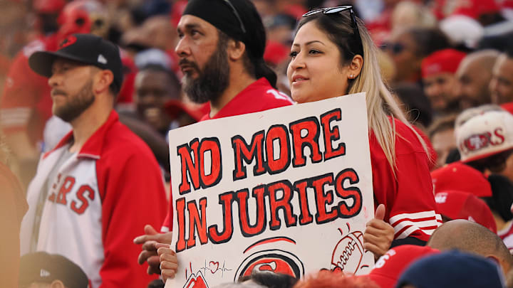 Oct 27, 2024; Santa Clara, California, USA; A San Francisco 49ers fan holds a sign reading “no more injuries” during the first quarter against the Dallas Cowboys at Levi's Stadium. Mandatory Credit: Kelley L Cox-Imagn Images