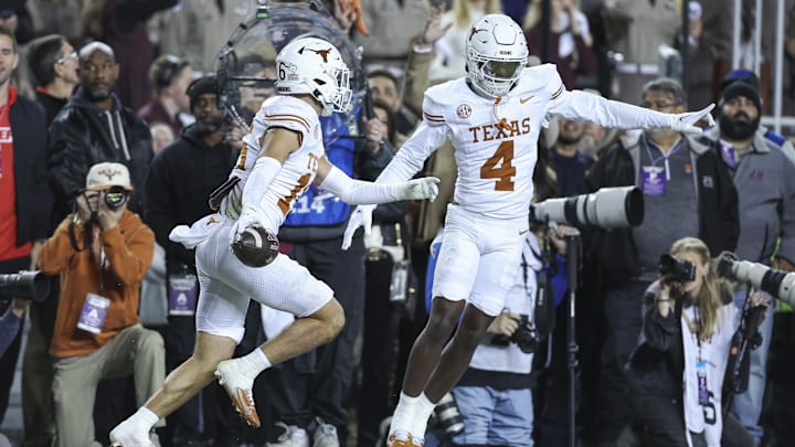 Nov 30, 2024; College Station, Texas, USA; Texas Longhorns defensive back Michael Taaffe (16) celebrates with defensive back Andrew Mukuba (4) after an interception during the first quarter against the Texas A&M Aggies at Kyle Field. 