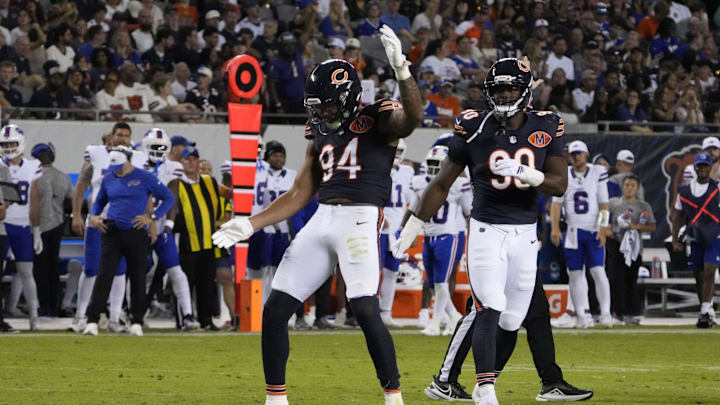 Bears defensive end Austin Booker (94) celebrates after sacking Bills quarterback Mike White (14) in the preseason. Bears defensive end Austin Booker (94) celebrates after sacking Bills quarterback Mike White (14) in the preseason.