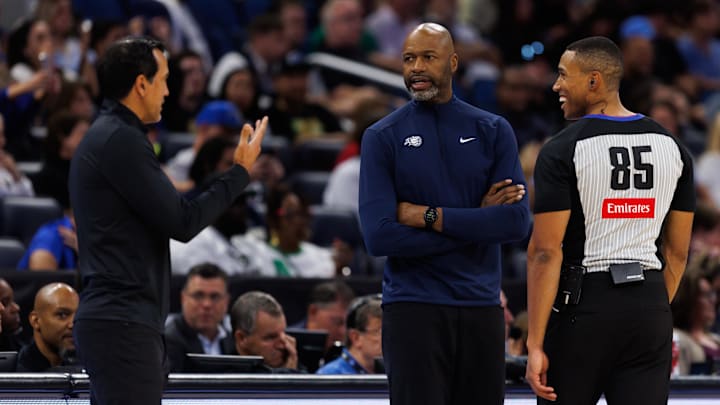 Oct 12, 2025; Orlando, Florida, USA; Miami Heat Head Coach Erik Spoelstra, Orlando Magic Head Coach Jamahl Mosley and NBA referee Robert Hussey react during a free throw during the first half at Kia Center. Mandatory Credit: Matt Pendleton-Imagn Images