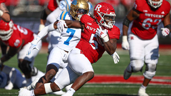 Rutgers Scarlet Knights running back Kyle Monangai gets past UCLA  DB K.J. Wallace last season.