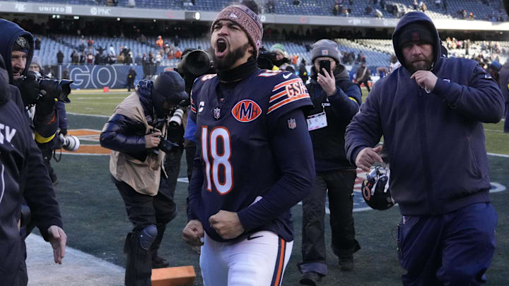 Caleb Williams celebrates a win in the cold over the Browns.