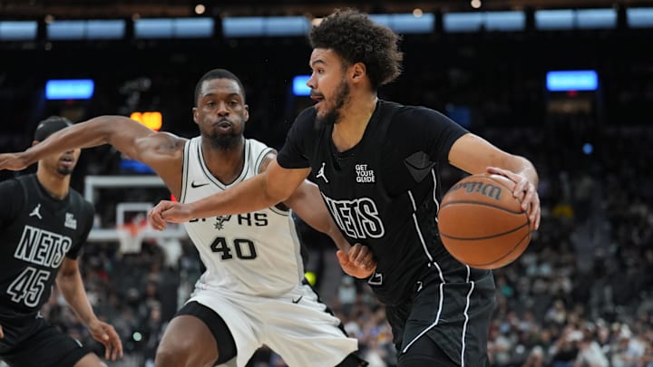 Mar 4, 2025; San Antonio, Texas, USA;  Brooklyn Nets forward Cameron Johnson (2) dribbles past San Antonio Spurs forward Harrison Barnes (40) in the second half at Frost Bank Center. Mandatory Credit: Daniel Dunn-Imagn Images