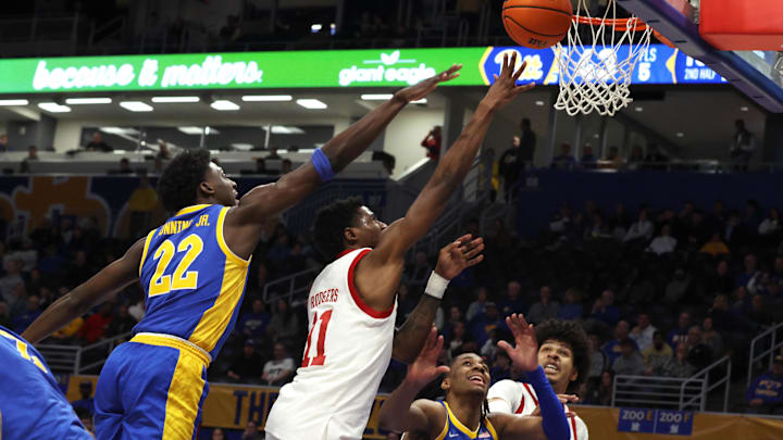 Jan 17, 2026; Pittsburgh, Pennsylvania, USA; Louisville Cardinals guard Kobe Rodgers (11) shoots against Pittsburgh Panthers guard Barry Dunning Jr. (22) during the second half at the Petersen Events Center. Mandatory Credit: Charles LeClaire-Imagn Images