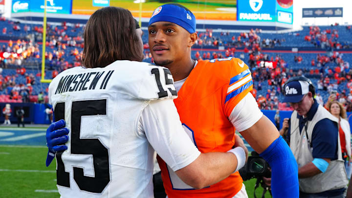 Oct 6, 2024; Denver, Colorado, USA; Las Vegas Raiders quarterback Gardner Minshew (15) and Denver Broncos cornerback Pat Surtain II (2) following the game at Empower Field at Mile High.