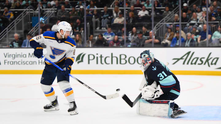 Apr 12, 2025; Seattle, Washington, USA; Seattle Kraken goaltender Philipp Grubauer (31) blocks a goal shot by St. Louis Blues left wing Nathan Walker (26) during the third period at Climate Pledge Arena. Mandatory Credit: Steven Bisig-Imagn Images