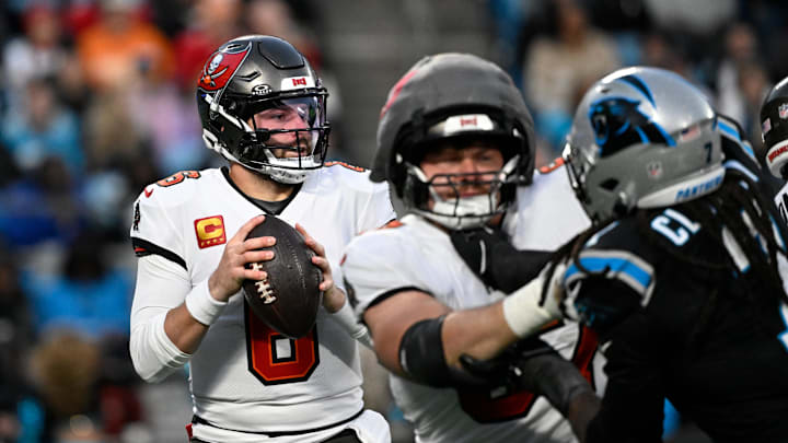 Dec 1, 2024; Charlotte, North Carolina, USA; Tampa Bay Buccaneers quarterback Baker Mayfield (6) looks to pass as Carolina Panthers linebacker Jadeveon Clowney (7) pressures in the second quarter at Bank of America Stadium. Mandatory Credit: Bob Donnan-Imagn Images Dec 1, 2024; Charlotte, North Carolina, USA; Tampa Bay Buccaneers quarterback Baker Mayfield (6) looks to pass as Carolina Panthers linebacker Jadeveon Clowney (7) pressures in the second quarter at Bank of America Stadium. Mandatory Credit: Bob Donnan-Imagn Images