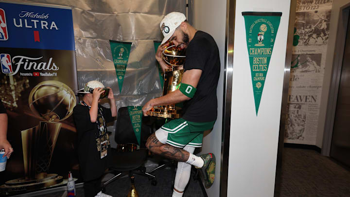 Jun 17, 2024; Boston, Massachusetts, USA; Boston Celtics forward Jayson Tatum (0) holds the Larry O’Brien Championship Trophy after their win against the Dallas Mavericks after game five of the 2024 NBA Finals at TD Garden. Mandatory Credit: Elsa/Pool Photo-Imagn Images