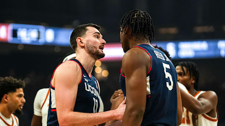 University of Connecticut forward Alex Karaban (11) talks to center Tarris Reed Jr. (5) during the game against the Texas Longhorns at the Moody Center on Sunday, Dec. 8, 2024.