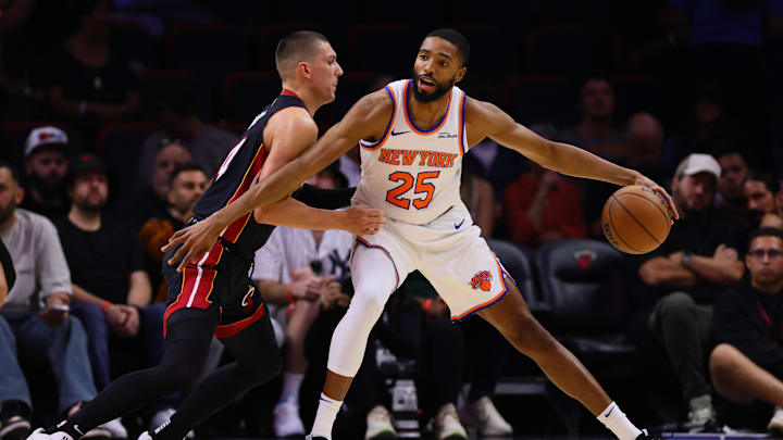 Oct 30, 2024; Miami, Florida, USA; New York Knicks forward Mikal Bridges (25) protects the basketball from Miami Heat guard Tyler Herro (14) during the first quarter at Kaseya Center. Mandatory Credit: Sam Navarro-Imagn Images