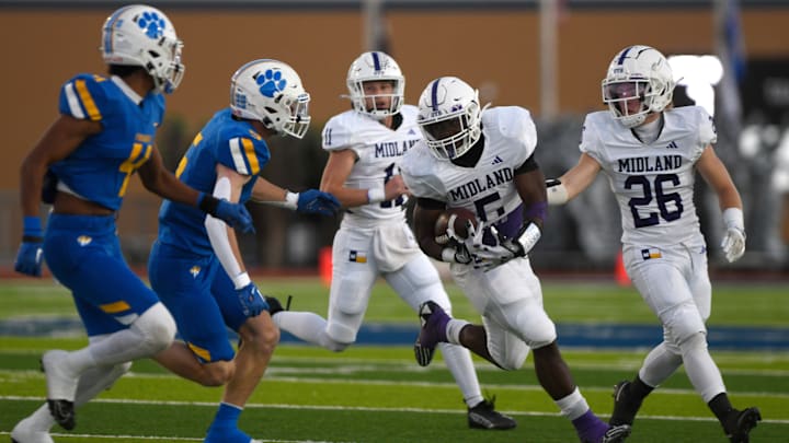 Midland High's Elijah McCoy, center, runs with the ball against Frenship in a District 2-6A high school football game, Friday, Oct. 13, 2023, at Peoples Bank Stadium in Wolfforth.
