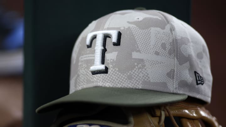 May 18, 2025; Arlington, Texas, USA;  Texas Rangers hat in honor of the military in the dugout  during the second inning against the Houston Astros at Globe Life Field. Mandatory Credit: Tim Heitman-Imagn Images