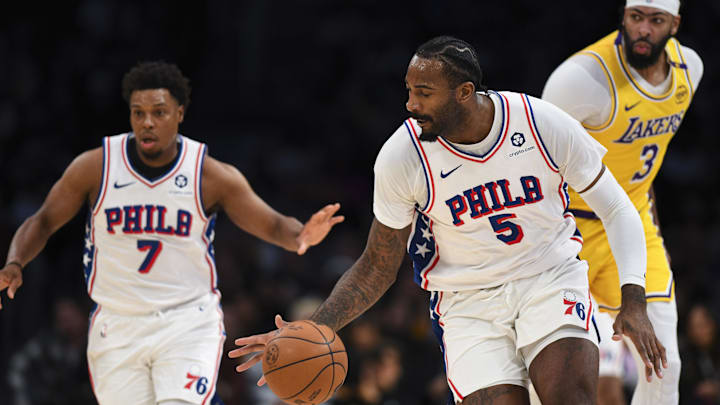 Nov 8, 2024; Los Angeles, California, USA; Philadelphia 76ers center Andre Drummond (5) moves the ball with guard Kyle Lowry (7) against Los Angeles Lakers forward Anthony Davis (3) during the first half at Crypto.com Arena. Mandatory Credit: Jonathan Hui-Imagn Images