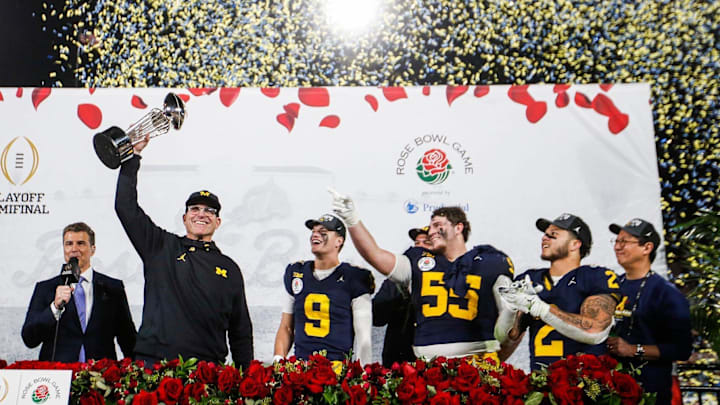 Jan. 1, 2024: Michigan head coach Jim Harbaugh lifts up the Rose Bowl trophy after a 27-20 win over
