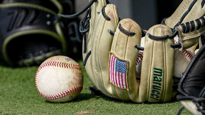 Baseball and US flag patch on a baseball glove before the top of the sixth inning at Doug Kingsmore Stadium in Clemson, S.C. Baseball and US flag patch on a baseball glove before the top of the sixth inning at Doug Kingsmore Stadium in Clemson, S.C.