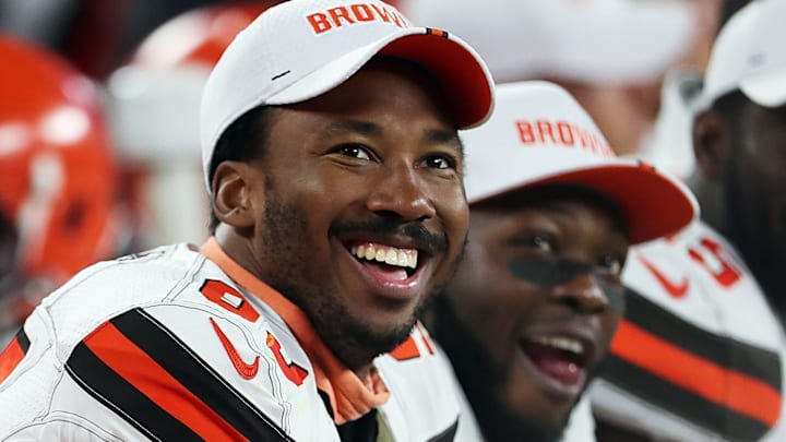 Cleveland Browns defensive end Myles Garrett (left) laughs as he watches a video on the scoreboard during a preseason game against Washington on Aug. 8, 2019, in Cleveland, Ohio.