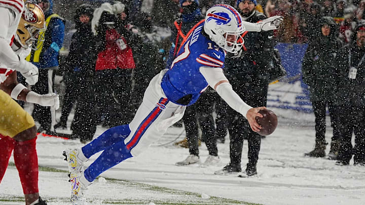 Bills Josh Allen leaps to the end zone in a nine-yard touchdown run after getting the ball passed back to him from Amari Cooper during second half action of their home game against the San Francisco 49ers in Orchard Park on Dec. 1, 2024.