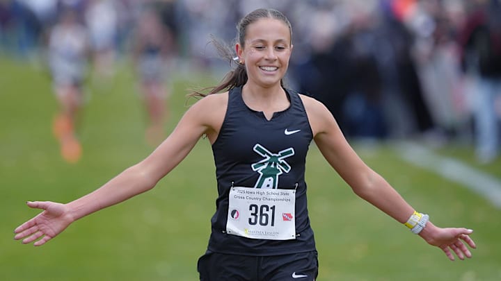 Pella’s Marissa Ferebee celebrates as finishing her race In the 3A girls state cross country meet at Lakeside Golf Course on Oct. 31, 2025, in Fort Dodge, Iowa. Ferebee won the 3A girls state cross country state title.