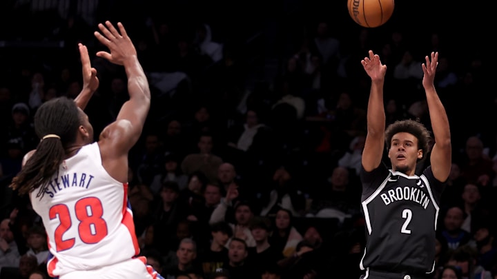 Dec 23, 2023; Brooklyn, New York, USA; Brooklyn Nets forward Cameron Johnson (2) attempts a three point shot against Detroit Pistons center Isaiah Stewart (28) during the second quarter at Barclays Center. Mandatory Credit: Brad Penner-Imagn Images