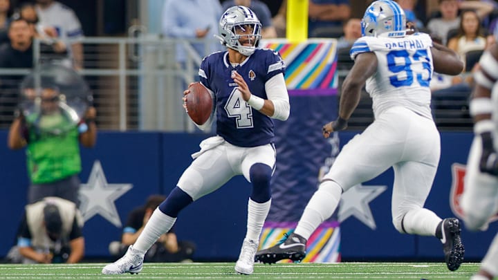 Dallas Cowboys quarterback Dak Prescott drops to pass with pressure from Detroit Lions defensive end Josh Paschal.
