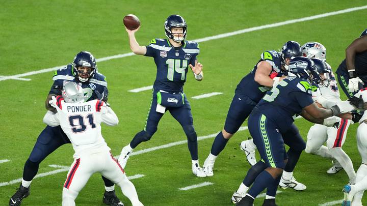 Seattle Seahawks quarterback Sam Darnold (14) throws a pass against the New England Patriots in the second half in Super Bowl LX. Seattle Seahawks quarterback Sam Darnold (14) throws a pass against the New England Patriots in the second half in Super Bowl LX.